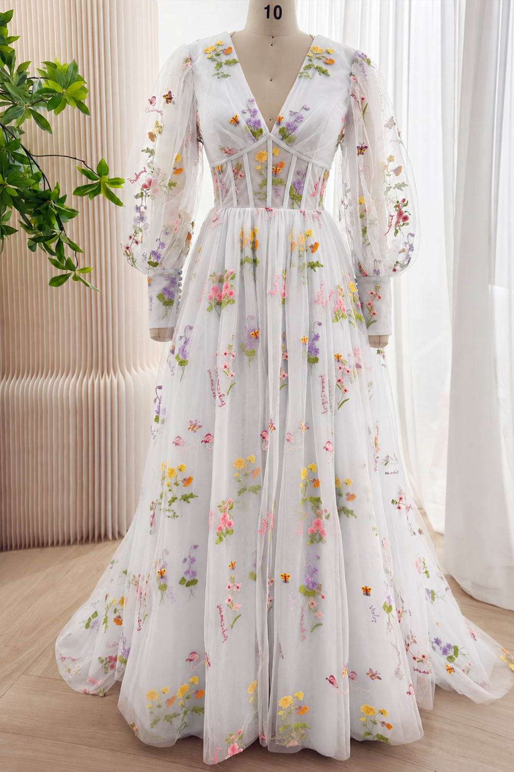 Ivory floral embroidered tulle gown with V-neck, sheer long sleeves, and full floor-length skirt