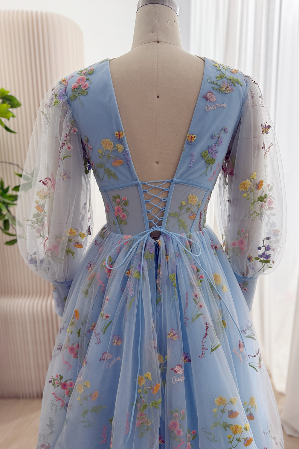 Full back view of the sky blue floral embroidered tulle gown with lace-up bodice and train