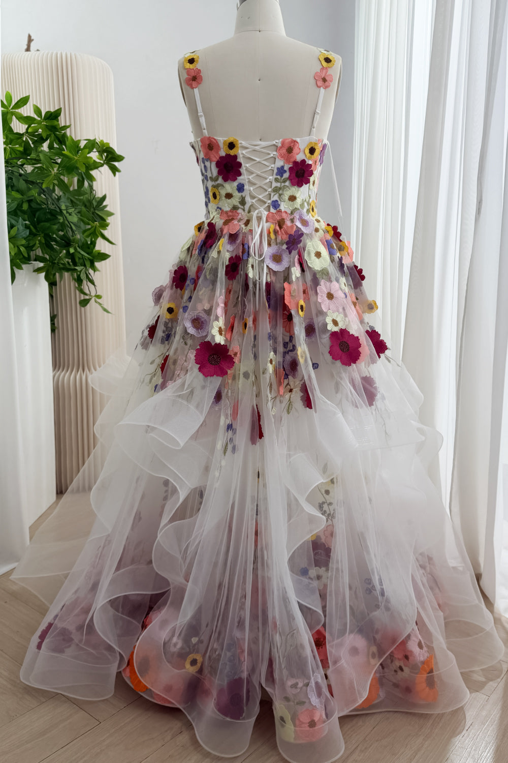 Full back view of the floral ball gown with a lace-up bodice and layered tulle skirt